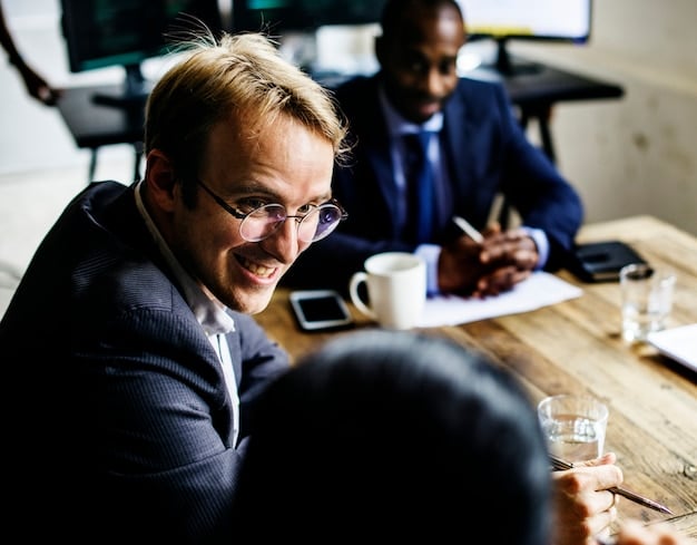 A close-up, professional shot of a financial advisor in a modern office setting, discussing tax implications with a client. The advisor is gesturing towards a tablet displaying charts and graphs, and the client appears engaged and thoughtful.
