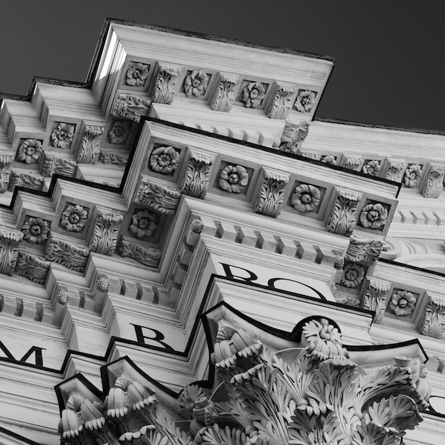 A split image showing a close-up of a U.S. dollar bill next to a close-up of a Federal Reserve building, symbolizing the interplay between monetary policy and currency value.