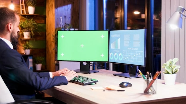 A person working at a desk with two monitors, illustrating how an external monitor can expand workspace and improve multitasking.