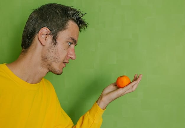 A person mindfully examining a vibrant piece of fruit, highlighting the importance of engaging all senses to fully appreciate the food.