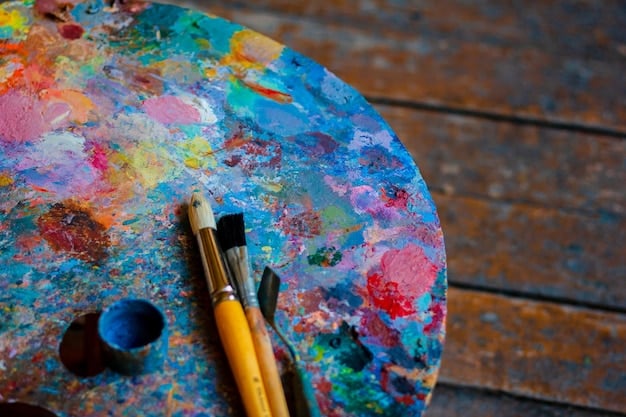 A close-up shot of a painter mixing colors on a palette, with various paintbrushes and a canvas in the background.
