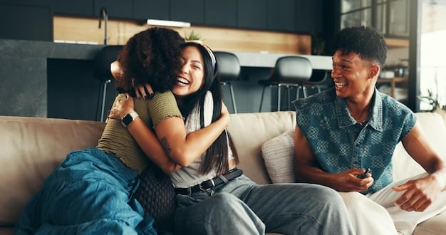 A couple is sitting on a couch, looking at each other and smiling while communicating effectively, showcasing a moment of connection and happiness.