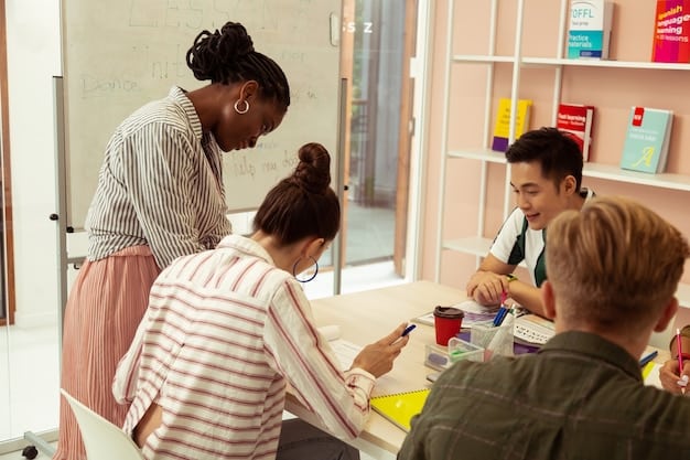 A teacher facilitating a small group activity where students are engaged in a hands-on project, demonstrating kinesthetic learning, while the teacher observes and provides guidance.