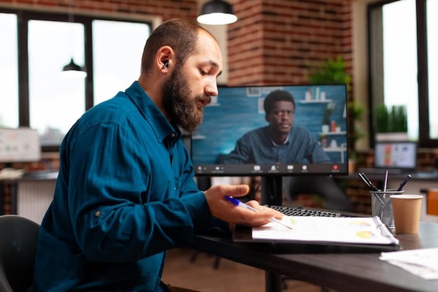 A young professional participating in an online workshop on a laptop in a modern office setting. The professional is taking notes and engaging with the content on the screen.
