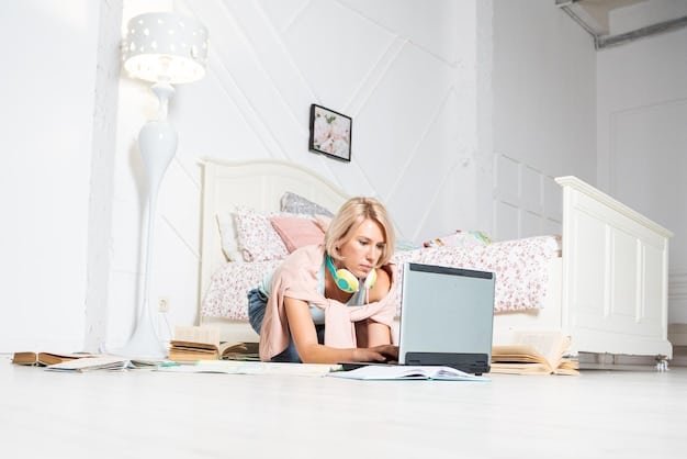 A child sitting at a desk in their bedroom studying with books and a laptop that is setup up for online learning. The room is brightly lit with posters, white walls, and organized bookshelves.