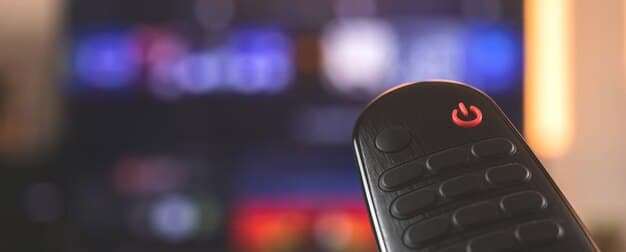 Close-up of a Chromecast device plugged into an HDMI port on a TV, with the Google logo visible. The background is slightly blurred, focusing on the Chromecast and its connection to the TV.