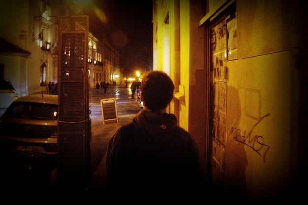 A dimly lit scene from a dorama, with a detective looking intensely at a crime scene, the atmosphere thick with suspense and intrigue, hinting at a complex mystery.