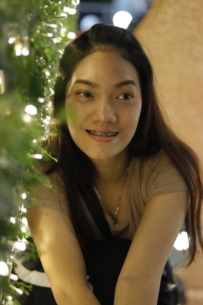 A candid portrait of Roh Yoon Seo, capturing her radiant smile and natural charm, with a blurry background that emphasizes her presence.